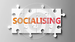 Socialising complex like a puzzle - pictured as word Socialising on a puzzle pieces to show that Socialising can be difficult and