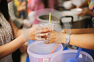 The Society of Sharing Food to Homeless and the Poorest: The Concept of Feeding : The hands of the rich give food to the hands of photo