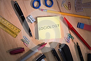 Sociology against students table with school supplies