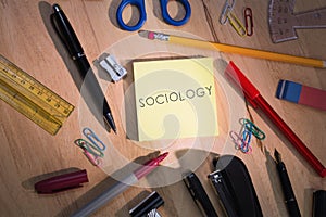 Sociology against students table with school supplies photo