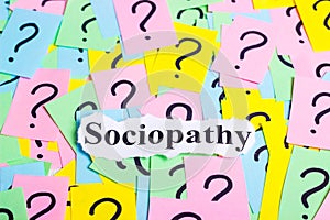 Sociopathy Syndrome text on colorful sticky notes Against the background of question marks