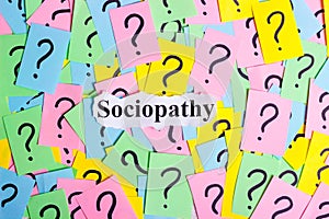 Sociopathy Syndrome text on colorful sticky notes Against the background of question marks photo