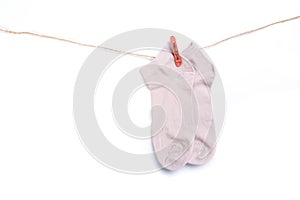 Sock hanging on a rope with clothespins isolated on white background
