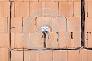 Socket back boxes with wires in a wall. Cabling background. Colorful electrical wires sticking out from electrical sockets. photo