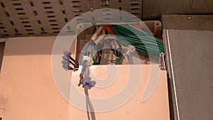 Socket back boxes with wires in a wall. Cabling background. Colorful electrical wires sticking out from electrical