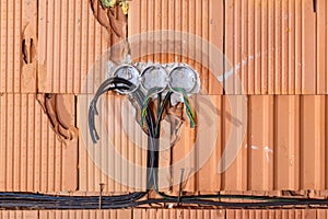 Socket back boxes with wires in a wall. Cabling background. Colorful electrical wires sticking out from electrical sockets hole.