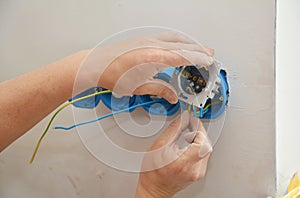 Socket box repair. Electrican repair and installing socket boxes, outlet plug. Socket plug and plastic socket boxes installation