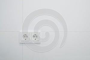 Socket, electric plug outlets on white tiles photo