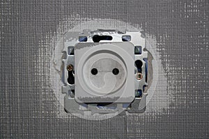 Socket on a gray-painted wall