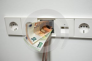 Socket and money on gray background