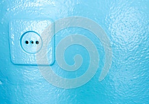 Socket with plug on a blue wall. electric plug and cord
