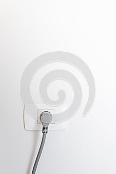 socket plug with electric plug line on white wall