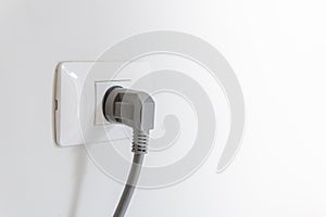 socket plug with electric plug line on white wall