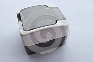 Socket with a protective cover against splashes on a white background, close-up