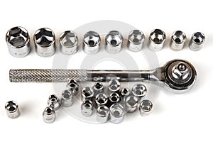 Socket spanner wrench and various wrench heads closeup on a white background