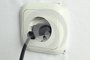 the socket is white on a white background with the black plug included. Electricity