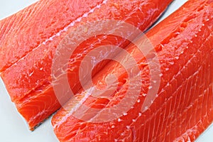 Sockeye salmon fillets on a white background.