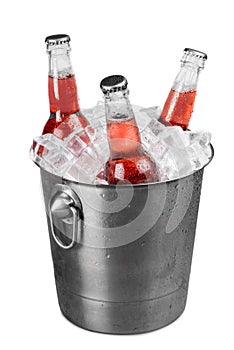 Soda bottles in a bucket filled with ice