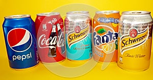 Soda cans collection isolated in yellow background