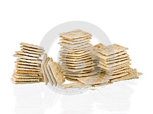 Soda crackers stacks half eaten isolated on white background