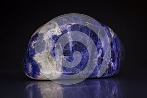 Sodalite gemstone on black background