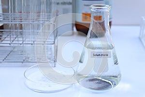 Sodium chloride in chemical container , chemical in the laboratory and industry photo