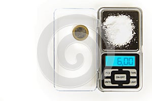 Sodium chloride - kitchen salt - 6 grams on scale with euro coin for compare