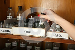 Sodium hydroxide bottle in hand photo