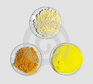 Sodium sulfide flake, Potassium Chromate and Organic Curcuma Powder in Chemical Watch Glass. Closeup chemical ingredient on white