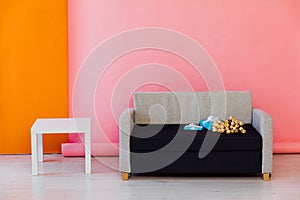 sofa with flowers and gifts coffee table on pink background interior in the room