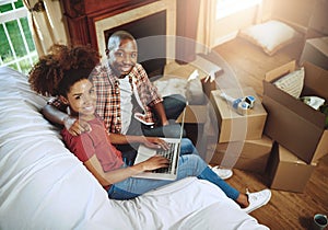 Sofa, laptop and portrait of couple in new house with smile for real estate, investment or mortgage loan. Man, woman and