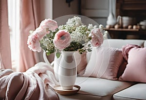 Sofa with pink pillows and a bouquet of flowers.