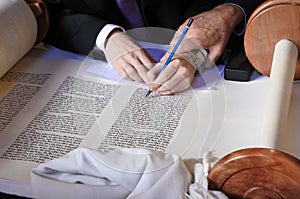 Sofer completing the final letters of sefer Torah