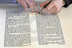 Sofer writing a sefer Torah in Hebrew