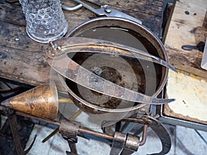 Soffieta, outside caliper and cutting edge scissors on glass blowing master table photo