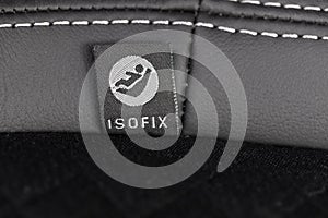 SOFIX sign on black leather background. ISOFIX for child car seats- Image photo