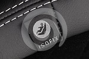 SOFIX sign on black leather background. ISOFIX for child car seats- Image photo