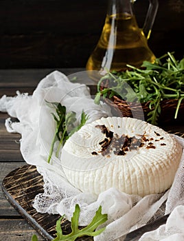 Soft Adyghe cheese with fresh rucola and dried tomatoes