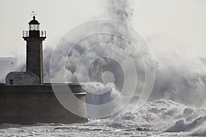 Soft backlit waves over old lighthouse