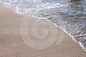 Soft beautiful ocean wave on sandy beach. Background.