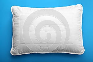 Soft bed pillow on color background