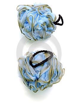 Soft blue bath puff or sponge on white background;