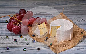 Soft blue cheese, ripe red grapes and decorative diamonds decoration