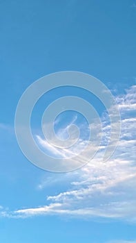 Soft Blue Sky with Wispy White Clouds