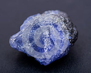 Soft blue violet rough TANZANITE from Tanzania isolated on black