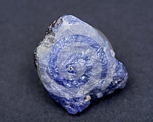 Soft blue violet rough TANZANITE from Tanzania isolated on black