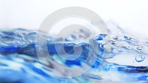Soft blur focus of Abstract water splash surface filling the frame with the water drop and waving liquid with an air bubble