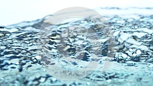 Soft blur focus of Abstract water splash surface filling the frame with the water drop and waving liquid with an air bubble