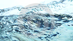 Soft blur focus of Abstract water splash surface filling the frame with the water drop and waving liquid with an air bubble