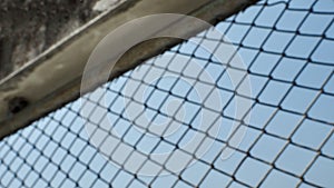 A soft blurred of the mesh metal fence